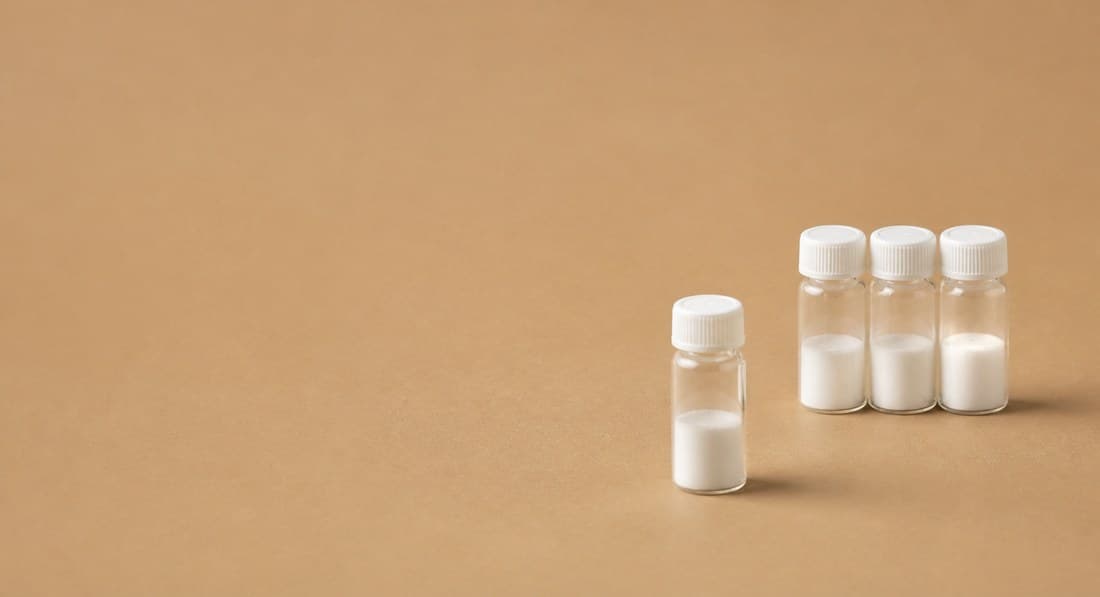 Four lyophilised-powder vials on a tan background
